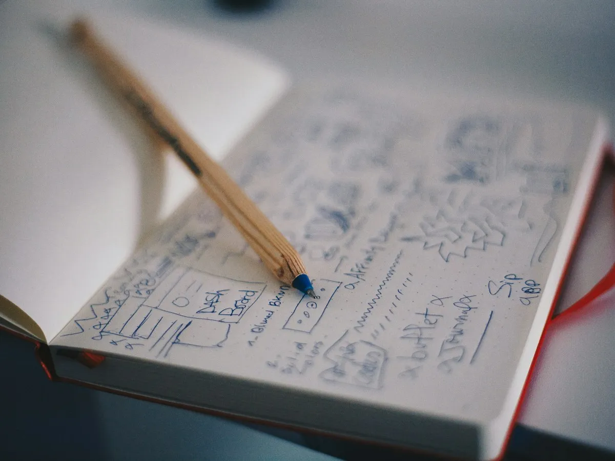 Brand identity sketches and colour studies arranged on a desk